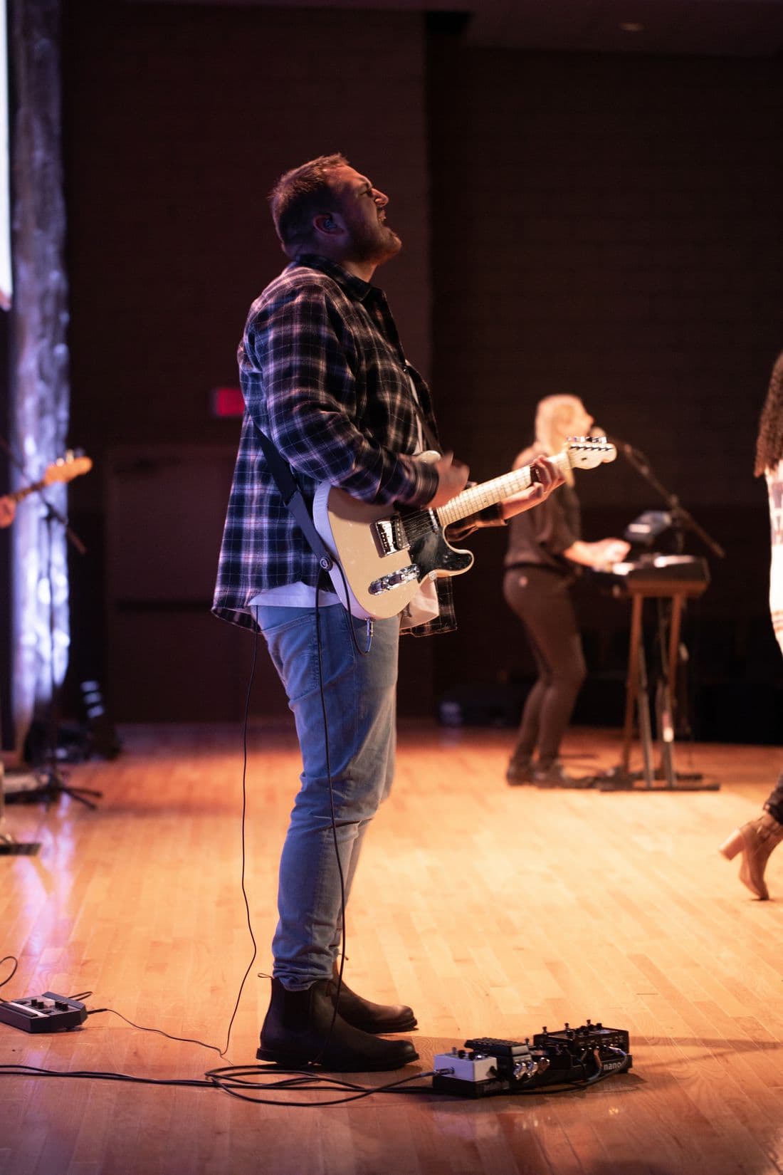 Samuel Tupy playing guitar at church